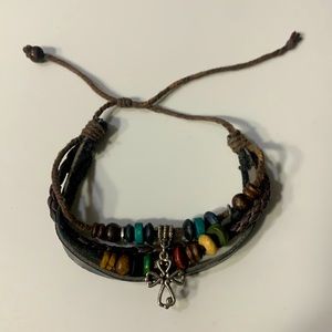 Brown leather like bracelet, worn(pic 2/3)but still very cute.